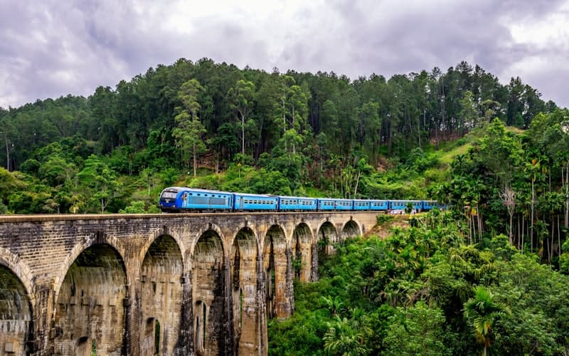 The blue train crossing the Nine Arches Bridge in Ella, Sri Lanka